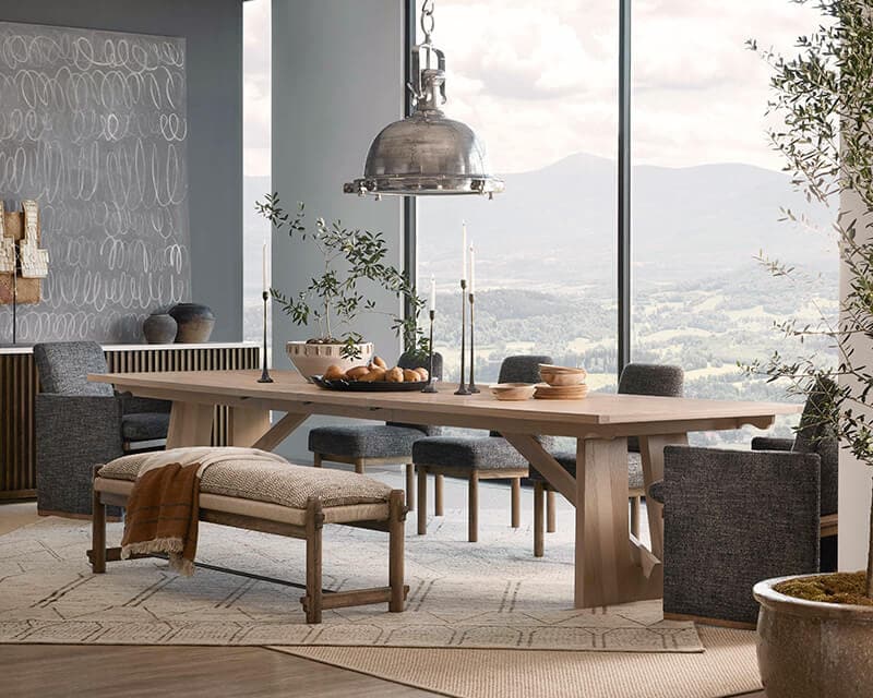A dining table with chairs and a bench against large picture window