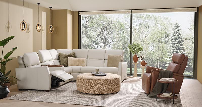 lifestyle photo with a tan sofa and a blue armchair with dark stained wooden arms